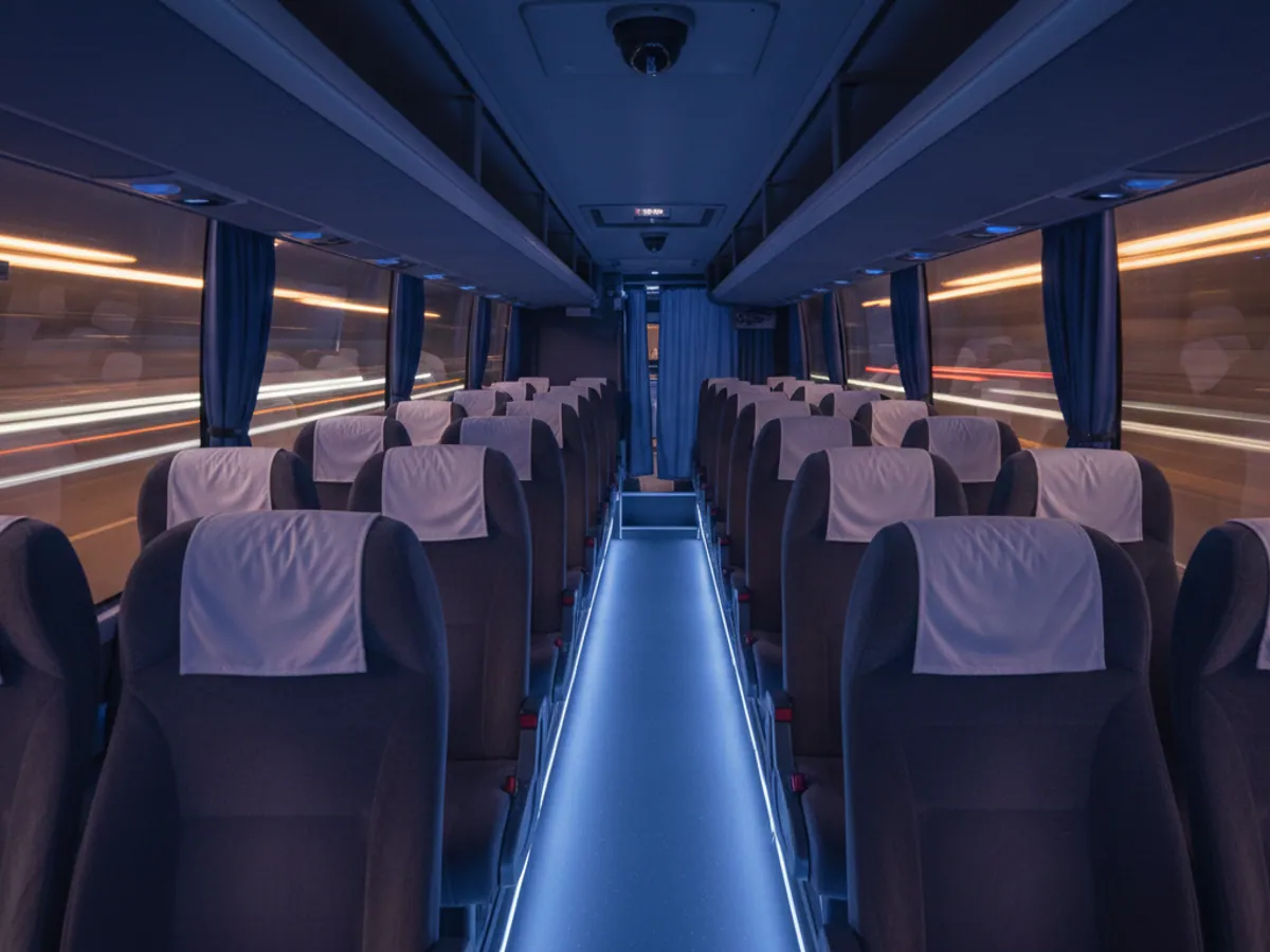 The cabin of an intercity coach at night, dome surveillance cameras on the ceiling