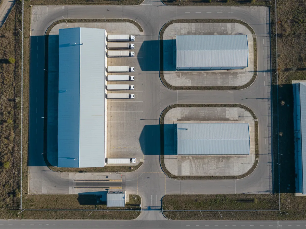 A view from above of a factory site: the gates, the weighbridge, loading bays with lorries and warehouses